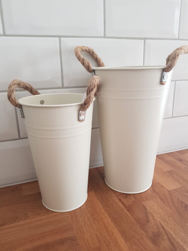 Two cream metal buckets